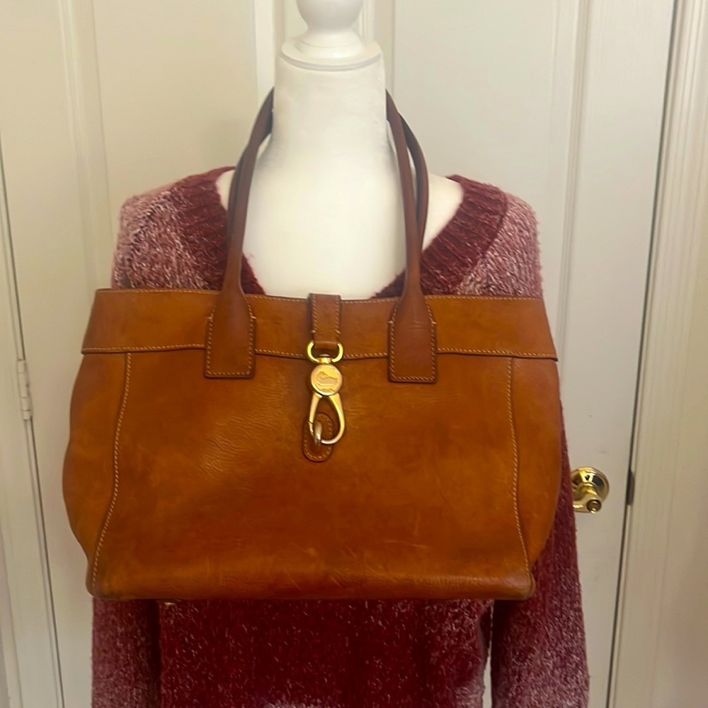 Tan leather Dooney and Bourke purse. wear and tear